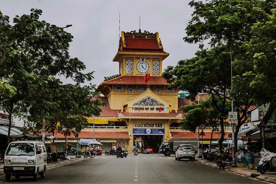 The yellow facade and central clock tower of Binh Tay Market in Cholon, Ho Chi Minh City