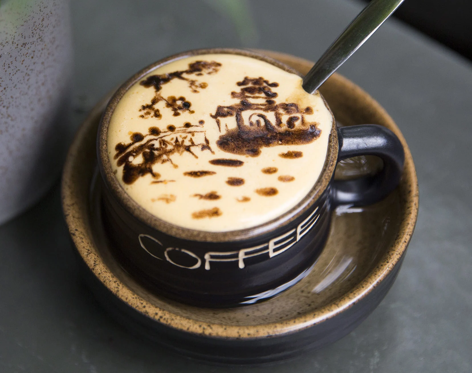 A cup of Vietnamese egg coffee (ca phe trung) with whipped egg yolk foam, served in Hanoi