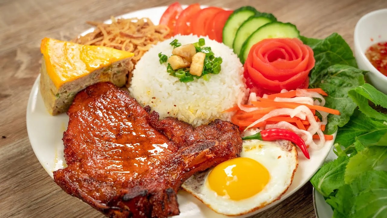 Com tam broken rice with grilled pork chop, fried egg and pickled vegetables, Saigon