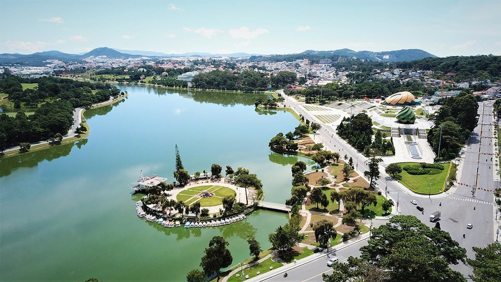 An aerial view of Xuan Huong Lake in the centre of Da Lat, with the town and hills around it