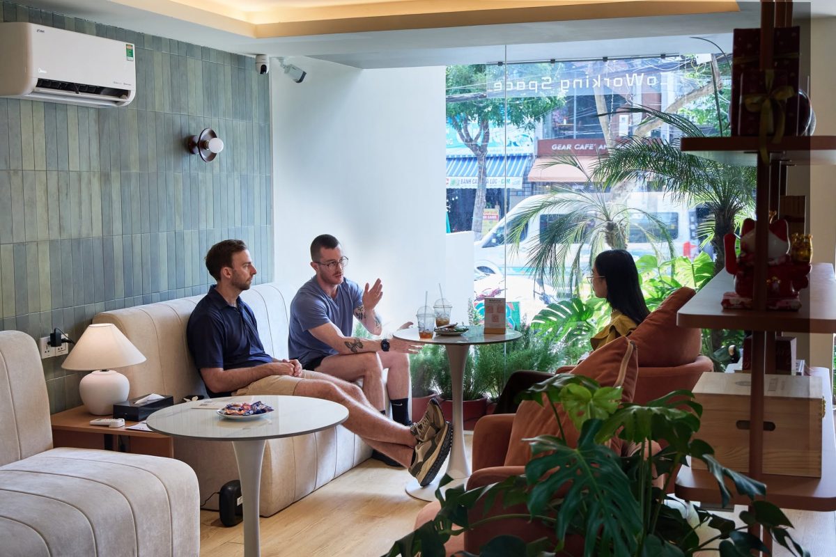 People relaxing at a cafe lounge next to a coworking space in Da Nang