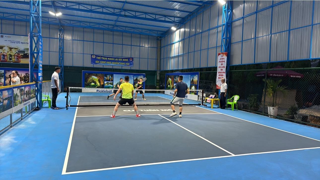 Players on a pickleball court in Dong Hoi, Quang Binh, in the early morning