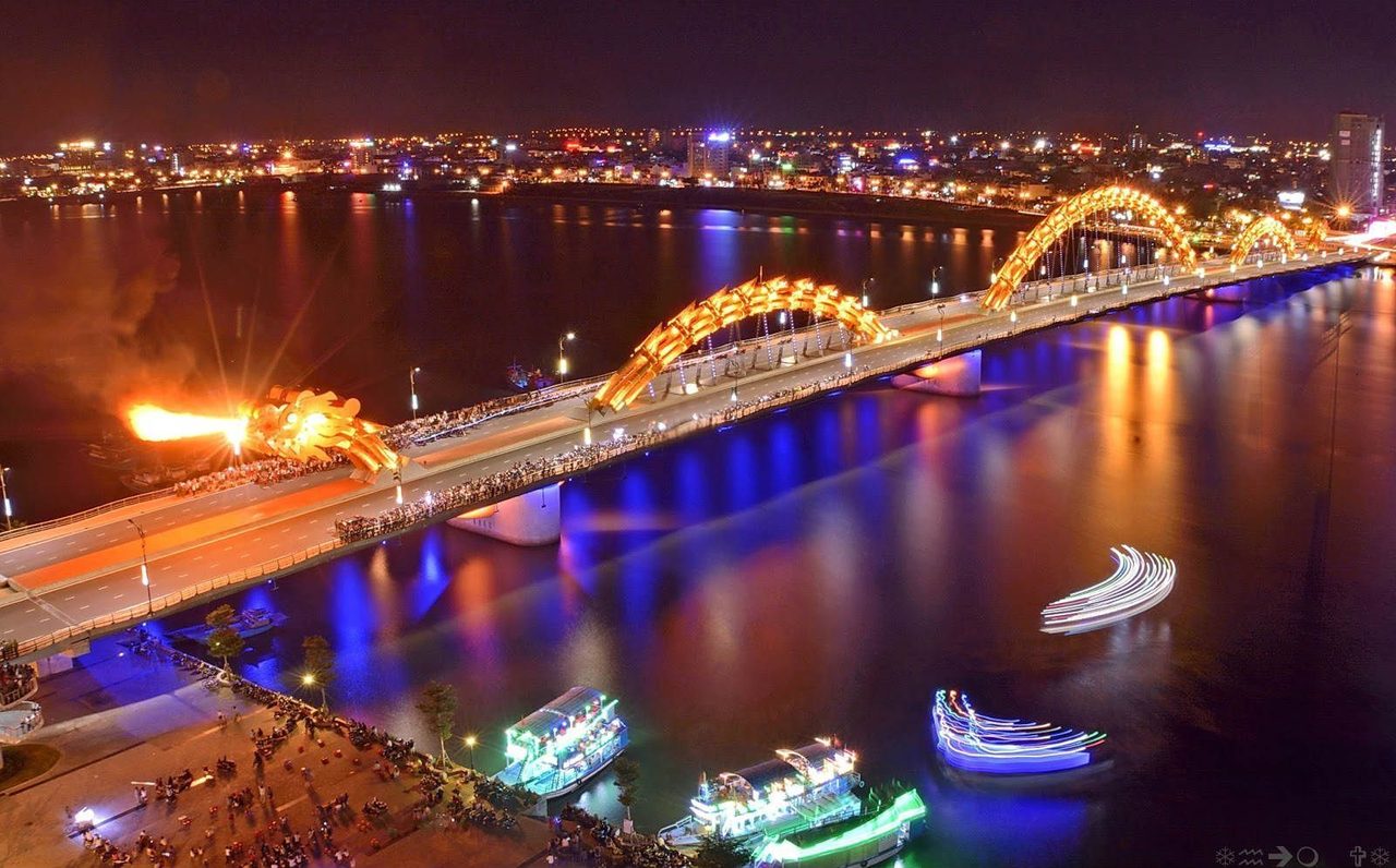 The Dragon Bridge in Da Nang lit up at night over the Han River