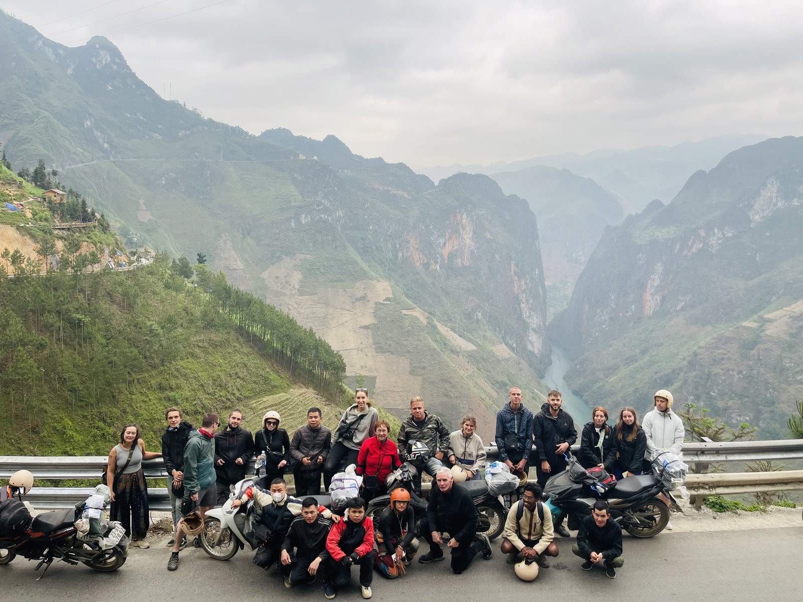 A traveller riding pillion behind a local driver on the Ha Giang Loop