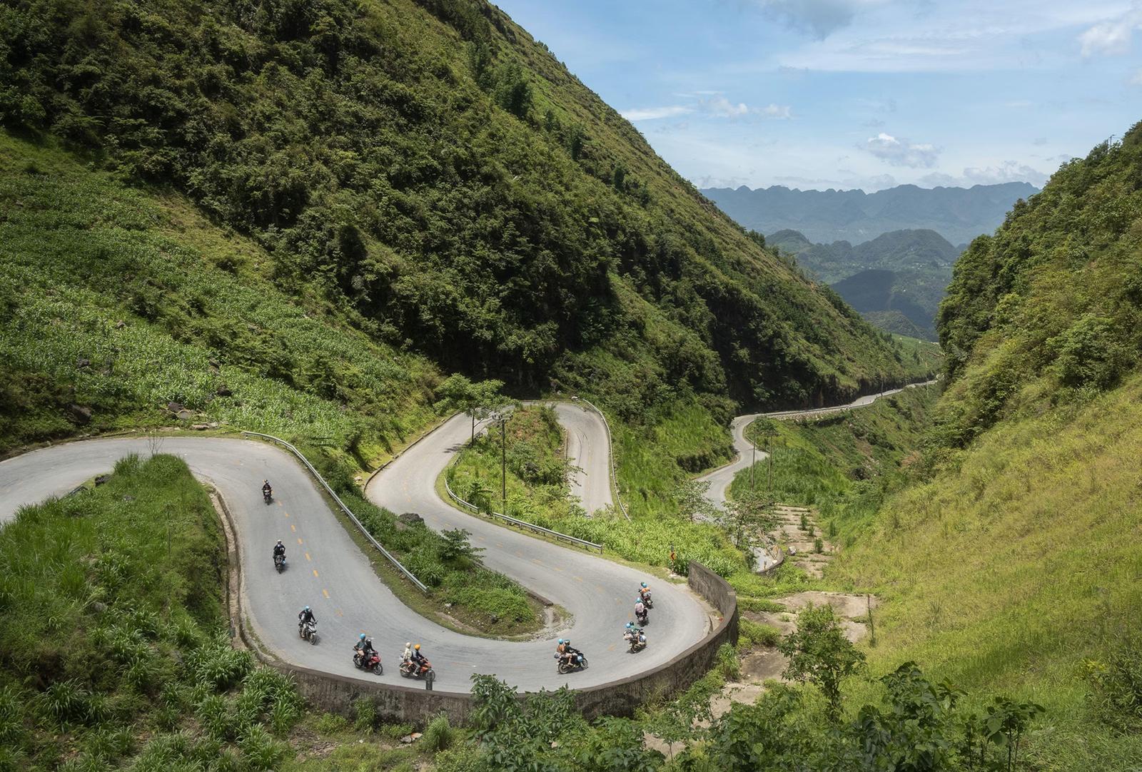 A motorbike on a winding mountain road on the Ha Giang Loop