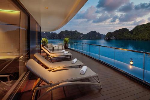 A cruise cabin with a private balcony overlooking the islands of Ha Long Bay