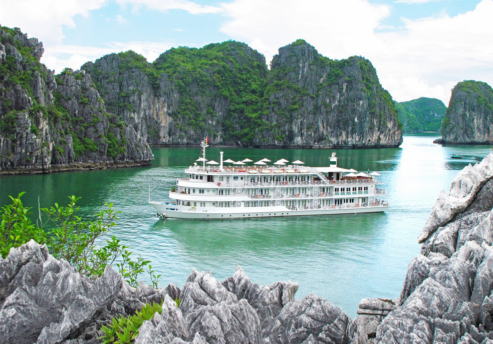 A cruise boat among the limestone islands of Ha Long Bay on a calm November day