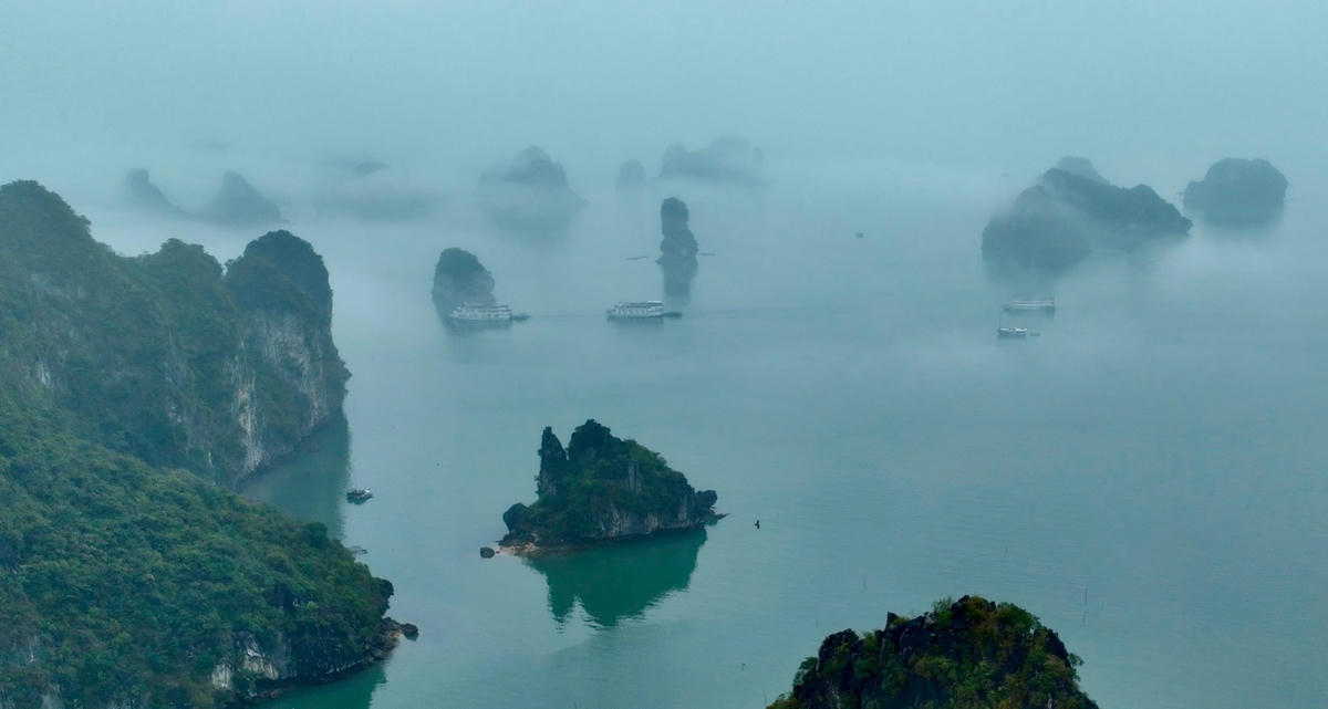 Mist over the limestone islands of Ha Long Bay on a winter morning