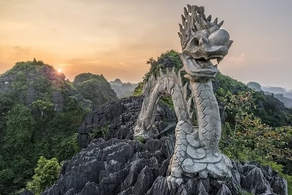 The stone dragon on top of Hang Mua looking over the Tam Coc valley in Ninh Binh