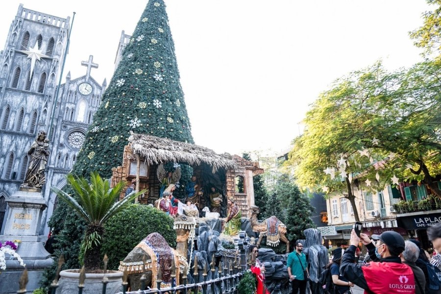 St Joseph's Cathedral in Hanoi lit up for Christmas with crowds gathered outside