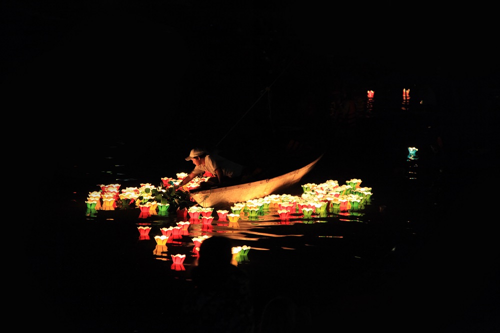 Paper candle lanterns floating on the Hoai River in Hoi An at night