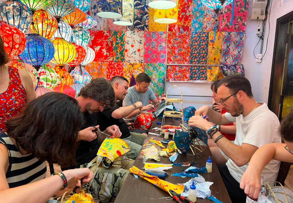 Visitors making their own silk lanterns at a lantern workshop in Hoi An