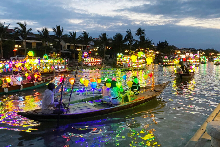 Wooden boats with paper lanterns on the Hoai River in Hoi An on full moon lantern night