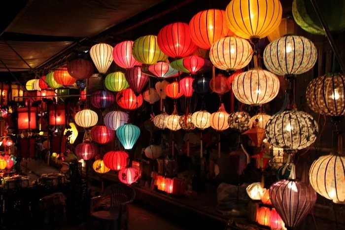 Silk lanterns glowing in a shop in Hoi An old town at night