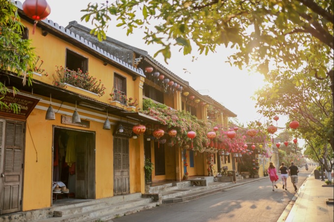 A quiet street of yellow shophouses in Hoi An old town