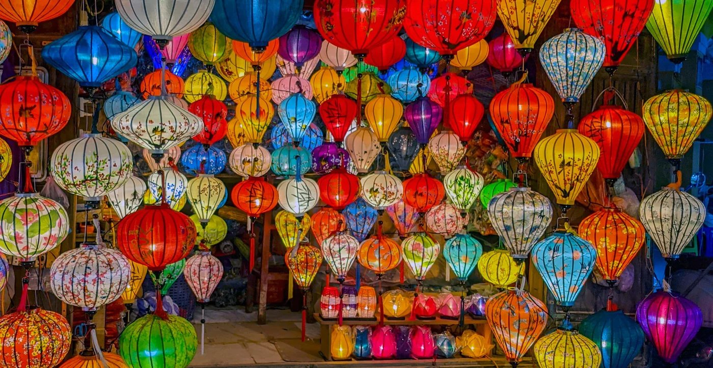 Colourful silk lanterns hanging in a lantern shop in Hoi An