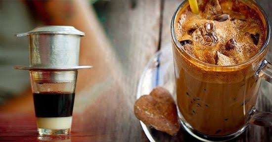 Vietnamese phin coffee filter dripping coffee into a glass with condensed milk