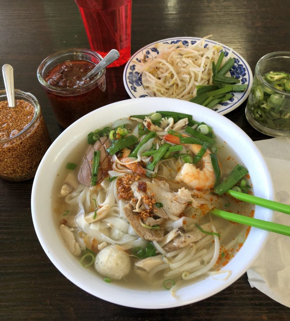 A bowl of hu tieu noodle soup with pork, shrimp and herbs in Ho Chi Minh City