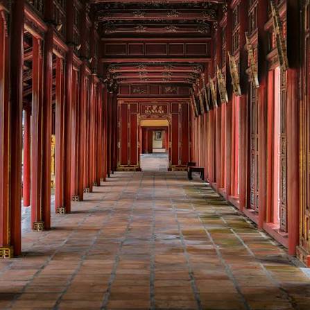 A long red covered corridor in the Forbidden Purple City inside Hue's Imperial City