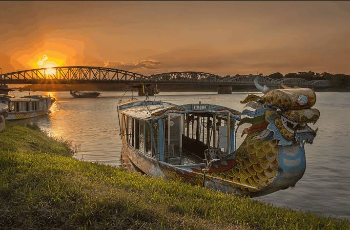 A dragon boat on the Perfume River in Hue at sunset