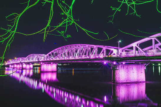 Truong Tien Bridge lit up at night over the Perfume River in Hue