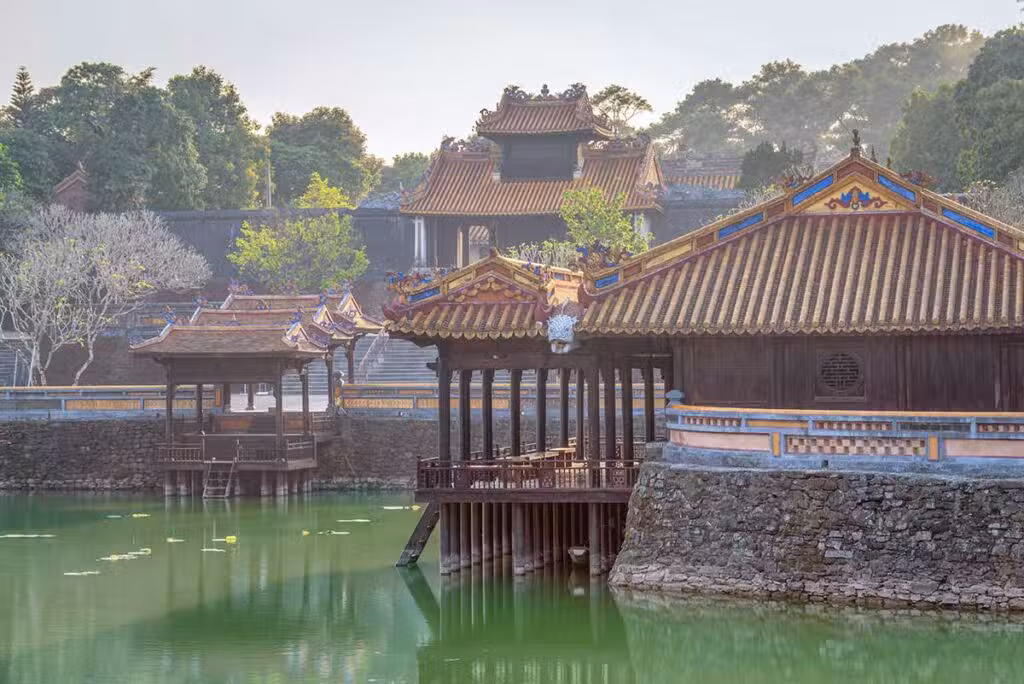 The lake and pavilions among pine trees at the Tu Duc Tomb in Hue