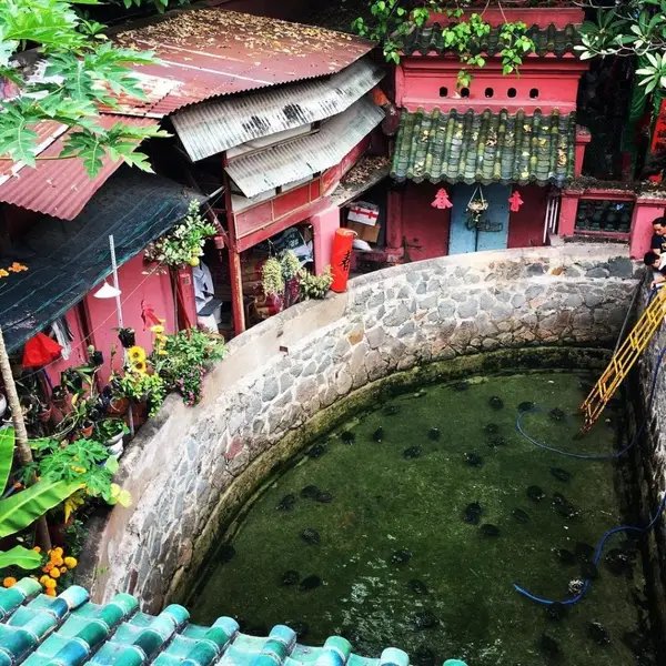 The turtle pond and red shrines in the courtyard of the Jade Emperor Pagoda, Ho Chi Minh City