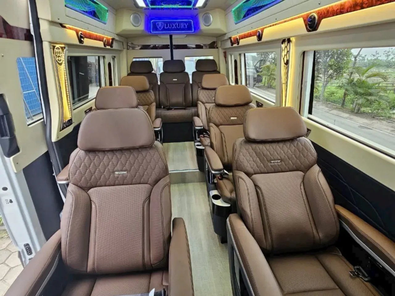 Inside a limousine van with brown leather reclining seats, the kind used between Hanoi and Ninh Binh