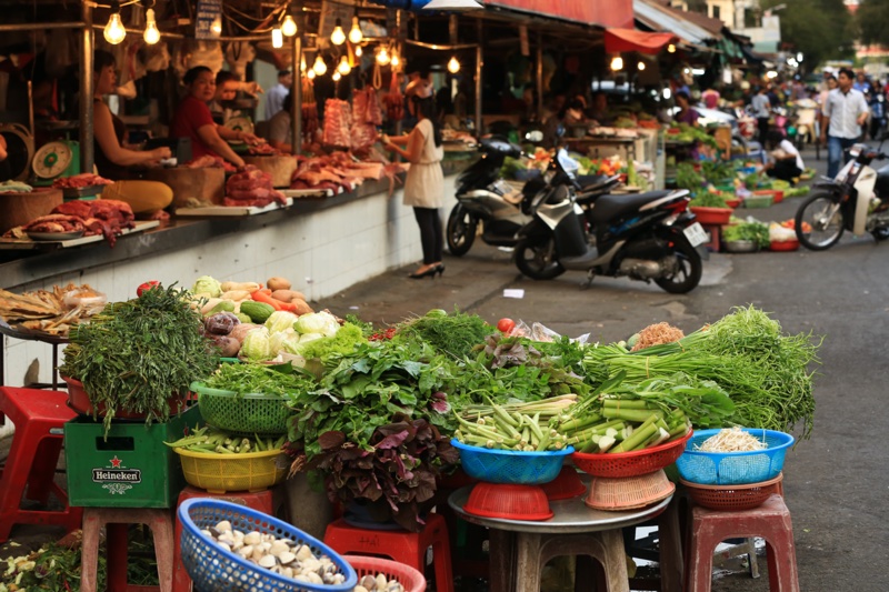 Fresh vegetables and herbs at a local wet market in Vietnam