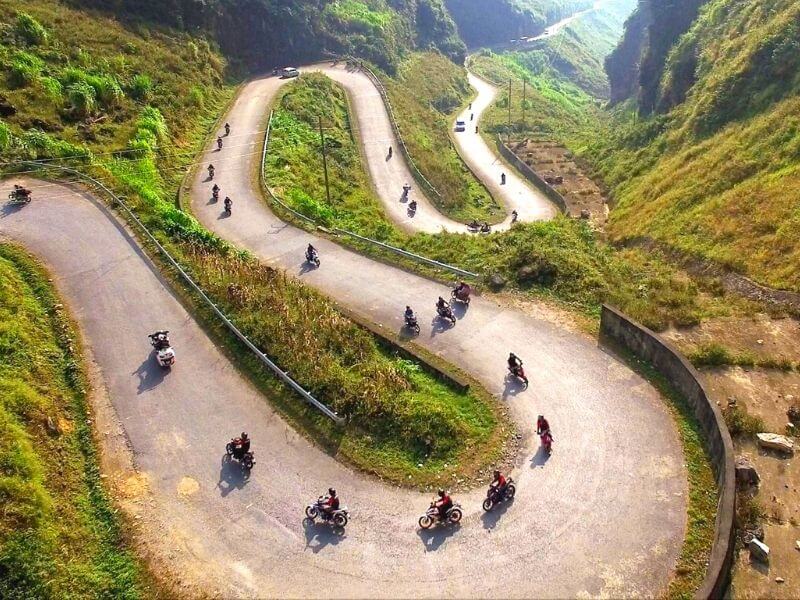 Motorbike riders on a switchback pass on the Ha Giang Loop in northern Vietnam
