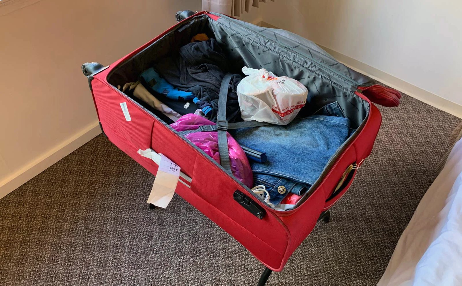 A man's pickleball kit laid out for a trip to Vietnam: shirts, shorts, court shoes and cap