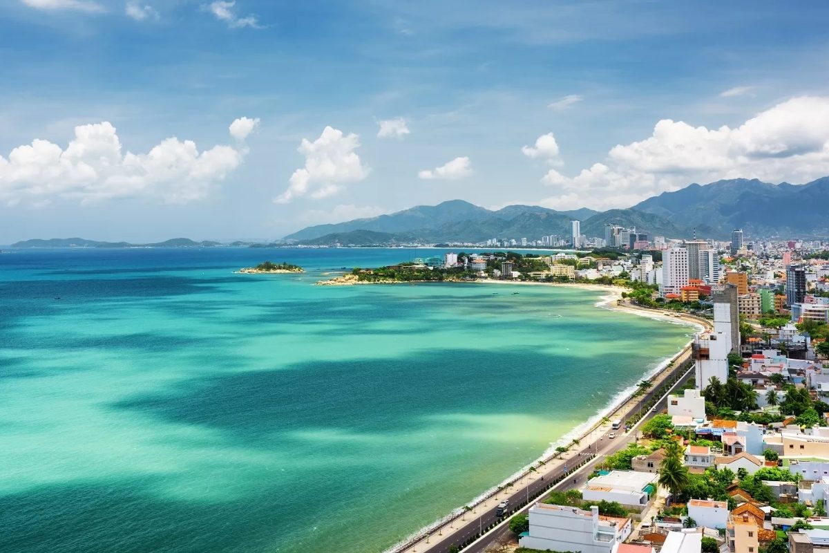 Nha Trang Bay from above at sunrise, with the beach almost empty and the ocean turning gold