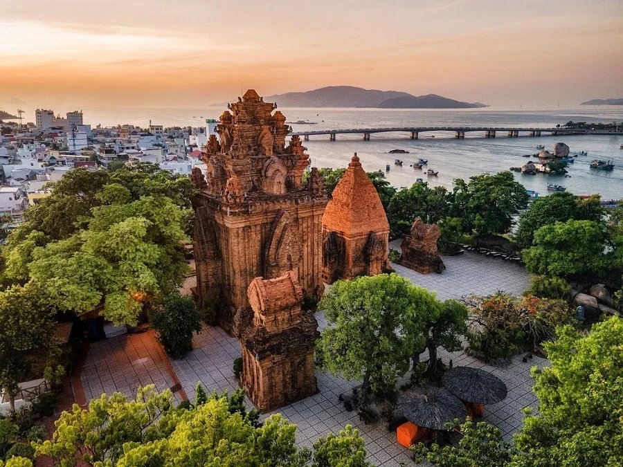 The Po Nagar Cham towers in Nha Trang at sunrise, ancient stone against a pale sky