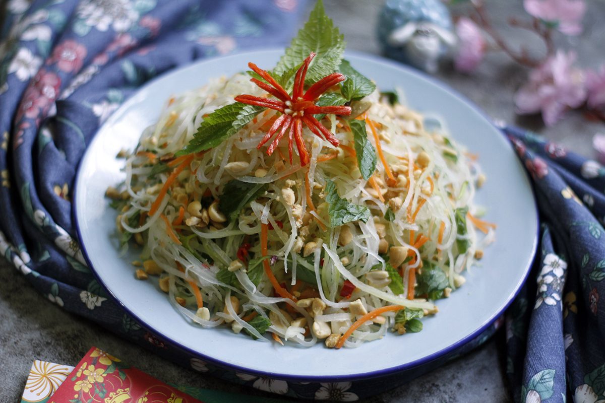 A Vietnamese glass noodle salad topped with crushed peanuts, herbs and chilli
