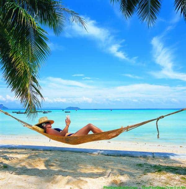 A hammock between coconut palms on a quiet beach in Phu Quoc