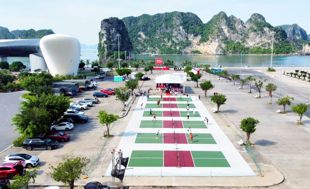 Outdoor pickleball courts in bright, humid sunshine by Ha Long Bay, Vietnam