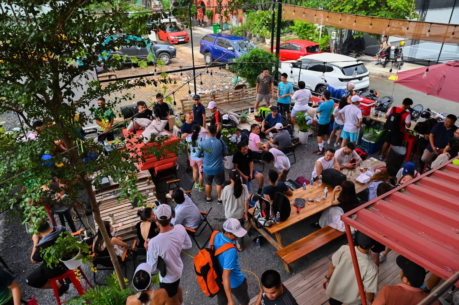Players relaxing at an outdoor table after a pickleball session in Thao Dien, Ho Chi Minh City