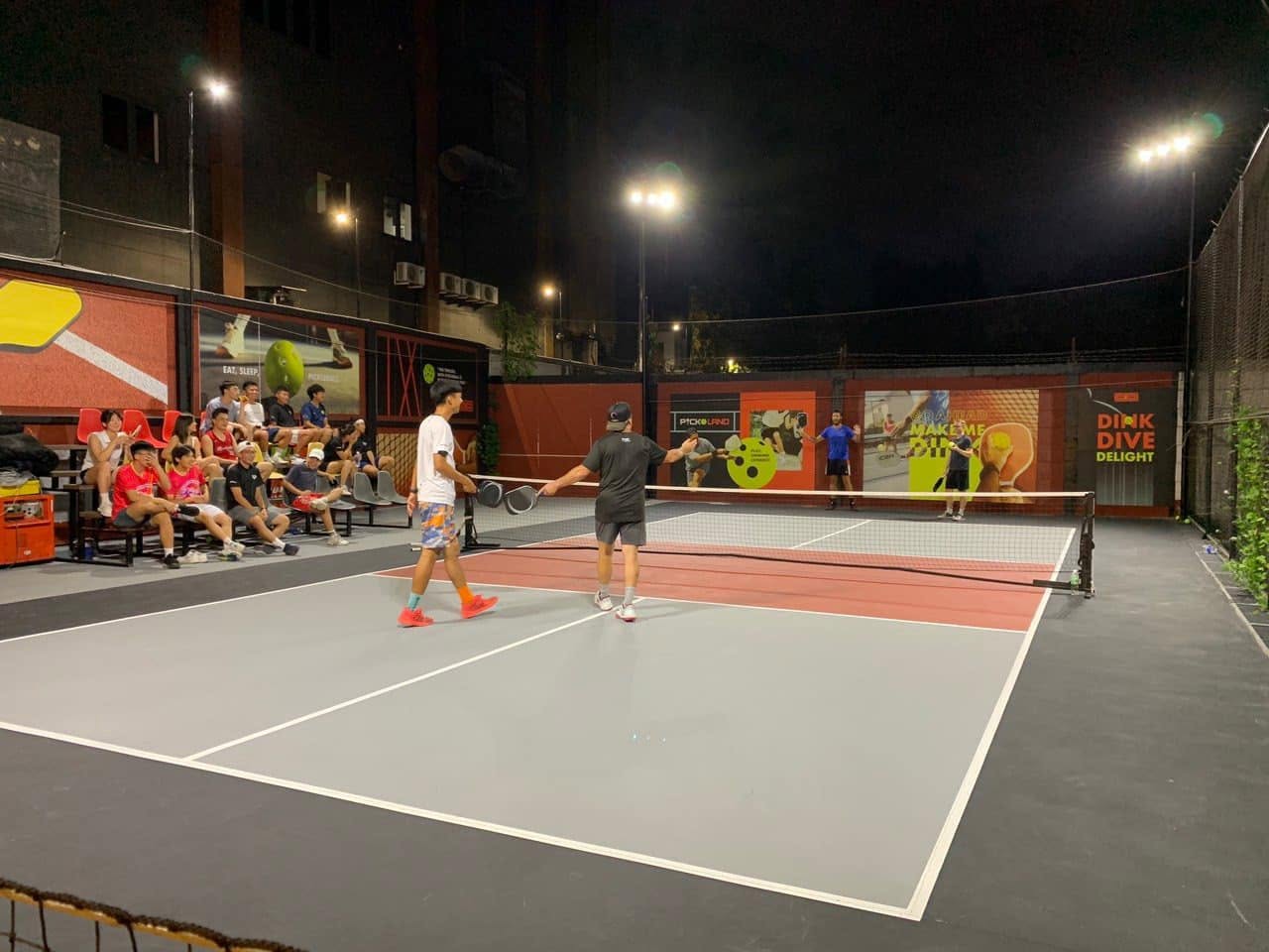 Players in a night match at PickoLand pickleball club in Thao Dien, Ho Chi Minh City