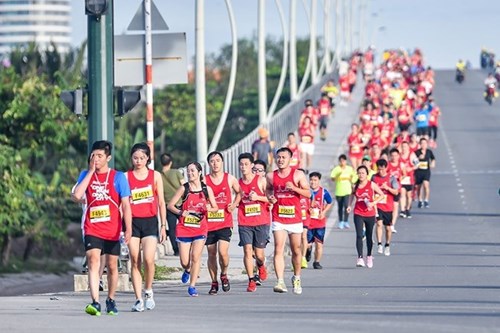 Runners crossing a bridge in Ho Chi Minh City during the international marathon in December