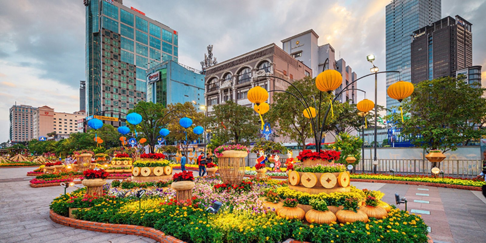 Families walking among flower displays on the Nguyen Hue flower street in Ho Chi Minh City at Tet