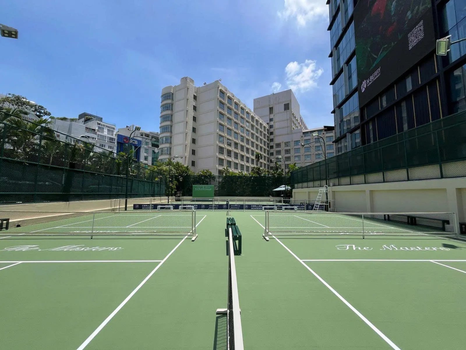 Players on an outdoor pickleball court in Ho Chi Minh City just after sunrise