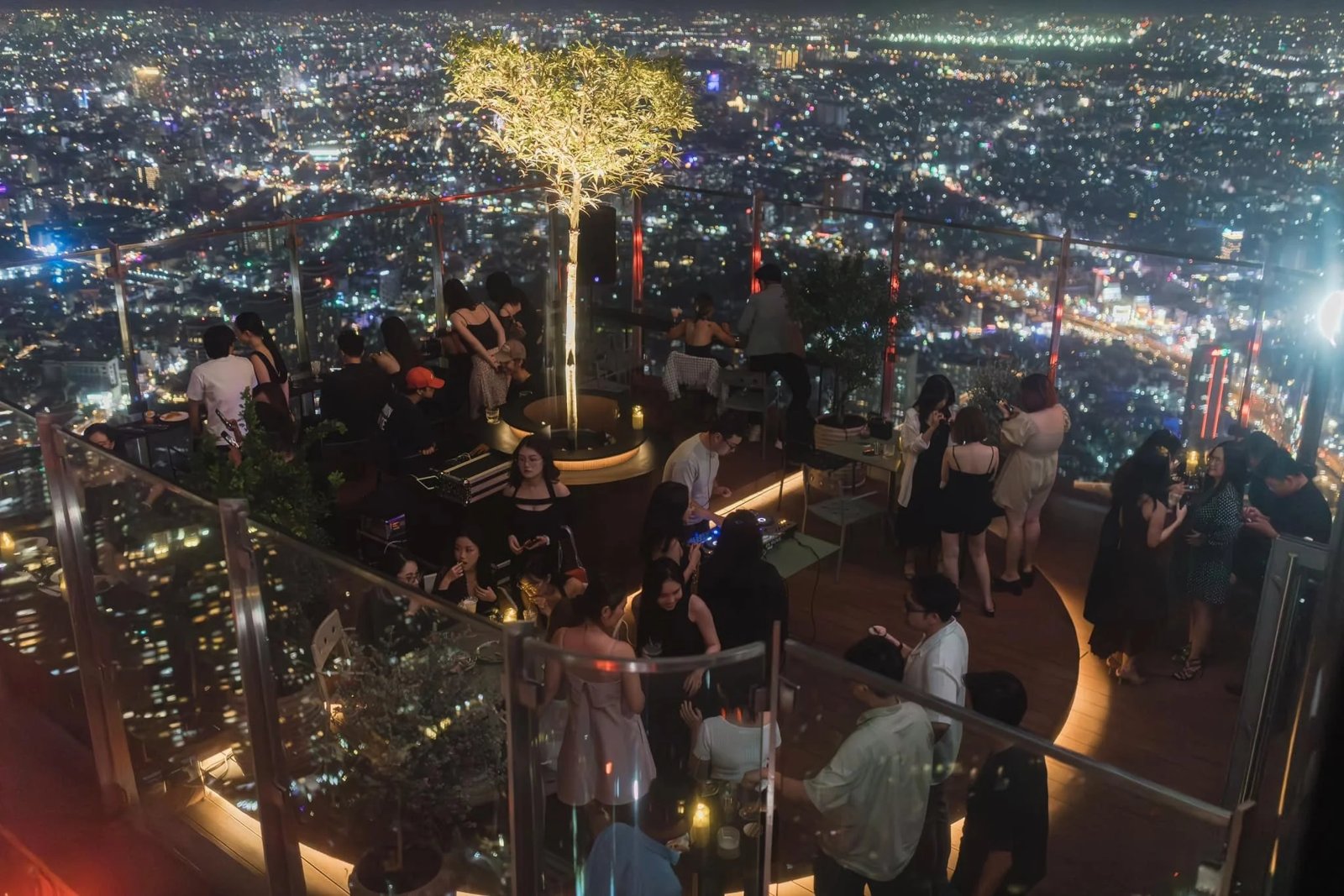 A rooftop bar overlooking the lights of the Ho Chi Minh City skyline at night