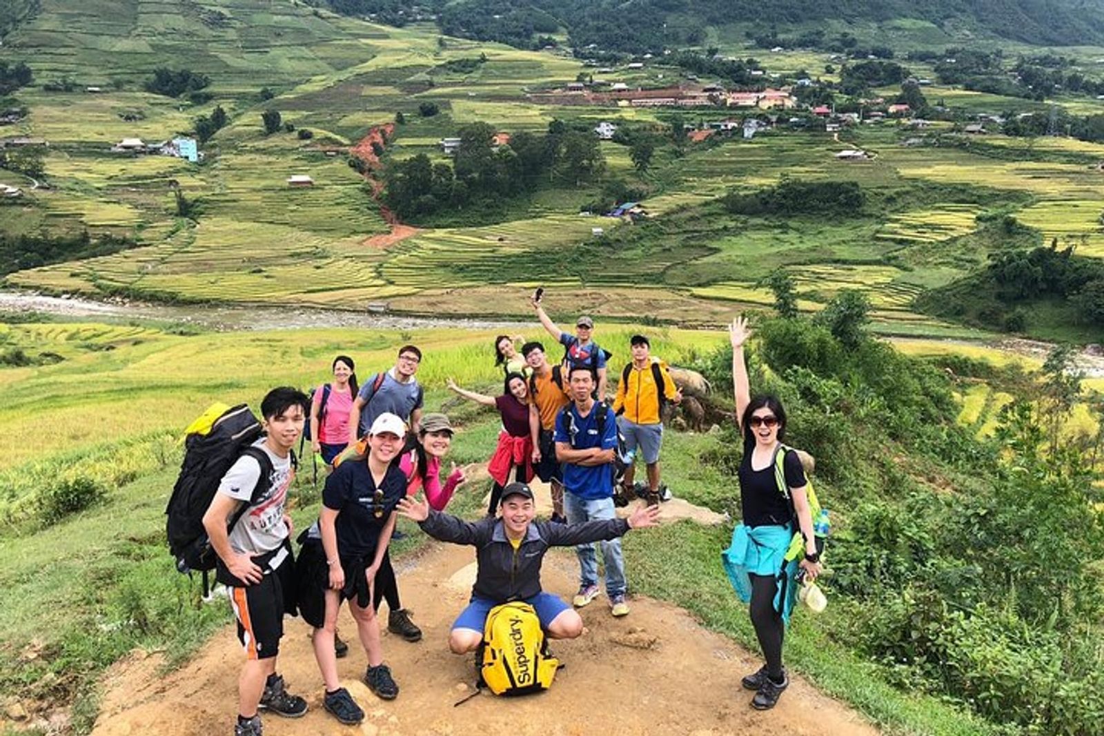 Trekkers walking through the terraced Muong Hoa Valley near Sapa