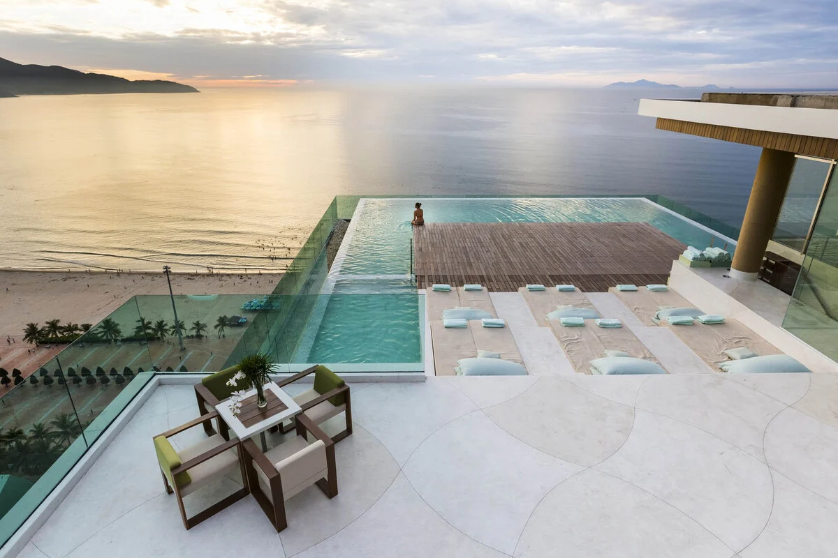 A rooftop infinity pool above the beach at a hotel in Da Nang, Vietnam