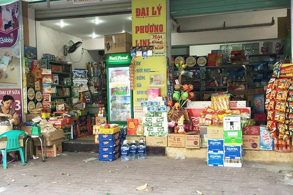 A Vietnamese market stall selling conical hats, rain ponchos and flip-flops