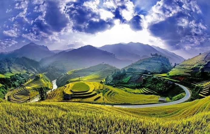 A mountain road winding past rice terraces in northern Vietnam