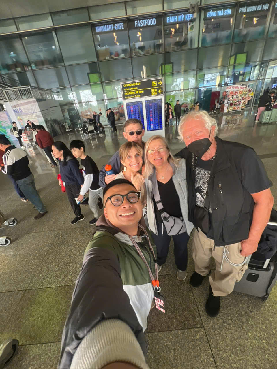 Older travellers met by a local guide on arrival at Noi Bai International Airport in Hanoi, Vietnam
