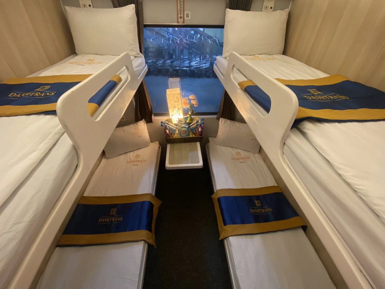 A soft sleeper cabin on a Vietnamese train with made-up lower berths