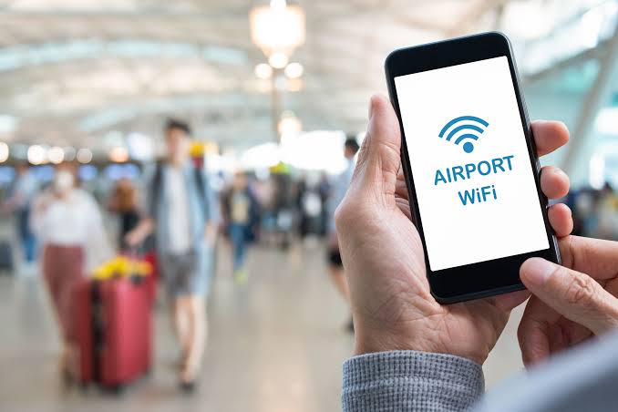 A traveller reading a WhatsApp message on a phone after landing at the airport