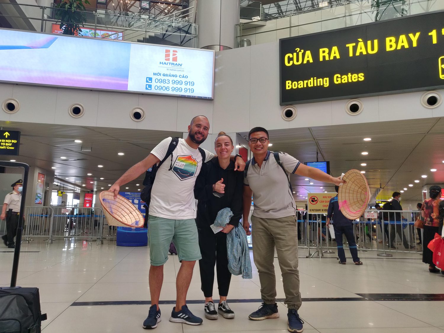 Kevin with two guests and their farewell gifts inside Noi Bai Airport in Hanoi